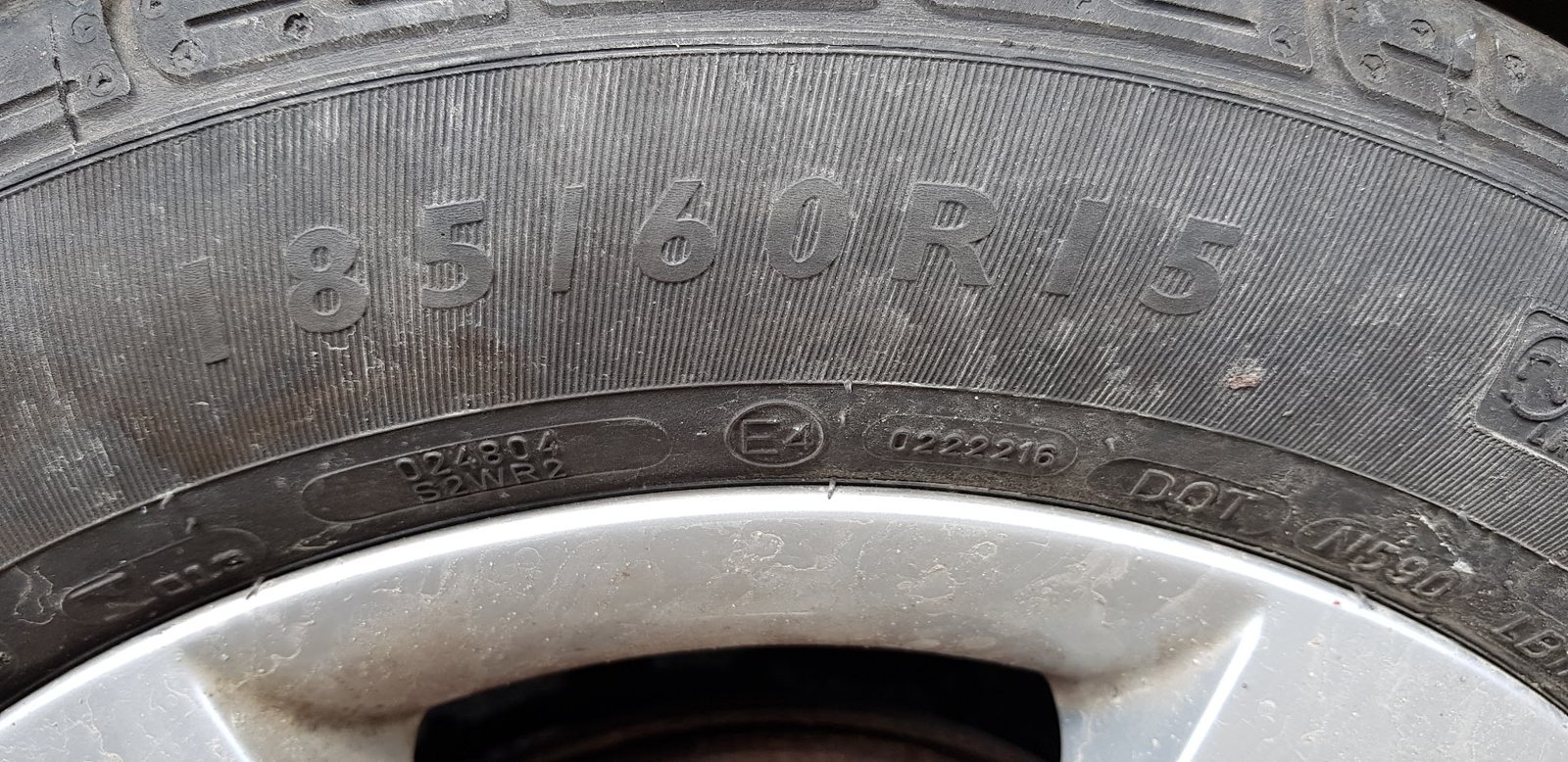 Close-up of a tyre sidewall showing its size, 185/60R15